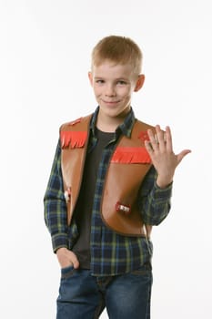 Portrait of a boy in a cowboys vest and raising his hand