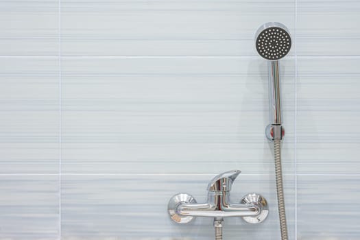 Blue tiled shower mixer and shower head