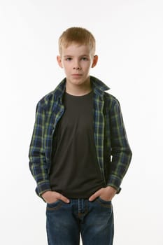 Portrait of a boy of ten years in a plaid shirt and jeans