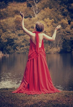 woman with beautiful dress by the lake
