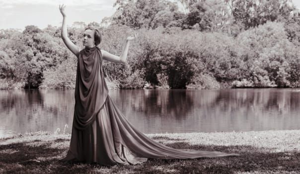 woman with beautiful dress by the lake