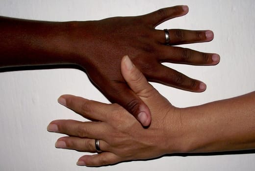 salvador, bahia / brazil - february 13, 2011: hand of black man and hand of white woman are seen together in the city of Salvador..