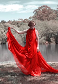 woman with beautiful dress by the lake