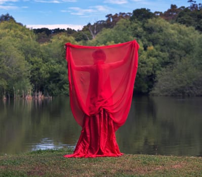 woman with beautiful dress by the lake