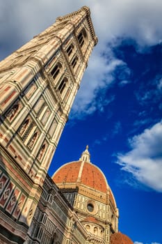 Street level view of Giotto's Bell Tower and Brunelleschi's Dome of Florence Cathedral in Italy