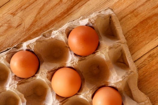 Thirty brown chicken eggs in a cardboard tray packaging. Raw fresh hen eggs in a carton box. Egg pattern background for easter, breakfast, cuisine. Top view