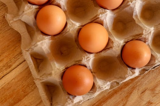 Thirty brown chicken eggs in a cardboard tray packaging. Raw fresh hen eggs in a carton box. Egg pattern background for easter, breakfast, cuisine. Top view