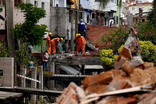 salvador, bahia / brazil - april 11, 2018: workers working on the demolition of irregular constructions in a stream in the neighborhood of Cosme e Farias in the city of Salvador..