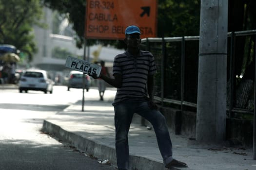 salvador, bahia / brazil - june 9, 2016: man is seen selling license plate near Detran headquarters in the city of Salvador.