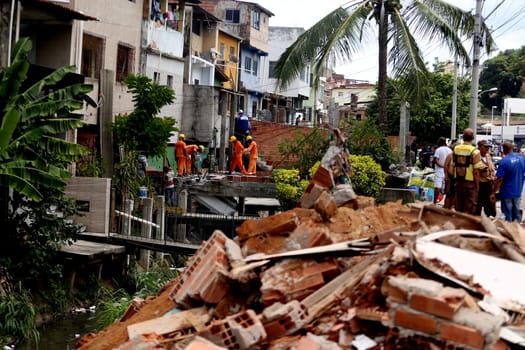 salvador, bahia / brazil - april 11, 2018: workers working on the demolition of irregular constructions in a stream in the neighborhood of Cosme e Farias in the city of Salvador..