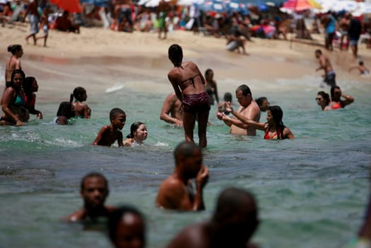 salvador, bahia / brazil - february 17, 2015: people are seen during a sea bath at Barra beach in the city of Salvador.
