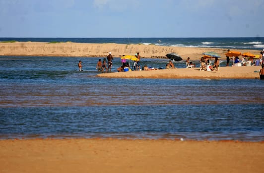 lauro de freitas, bahia / brazil - january 16, 2017: people are seen at the mouth of the Joanes River in the neighborhood of Buraquinho, in the city of Lauro de Freitas.