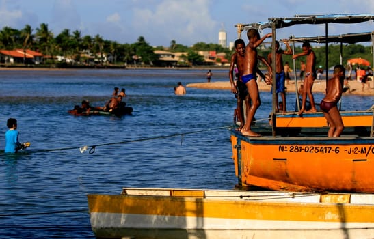 lauro de freitas, bahia / brazil - january 16, 2017: people are seen at the mouth of the Joanes River in the neighborhood of Buraquinho, in the city of Lauro de Freitas.