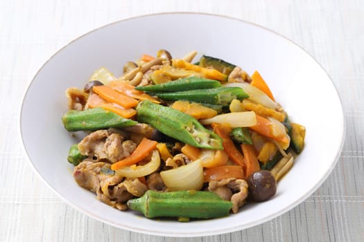 Vegetable stir fry in a plate on white background. Close up