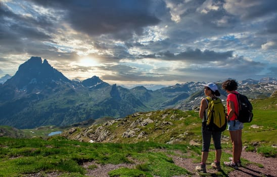 two hiker women in path of Pic du Midi Ossau in the french Pyrenees mountains