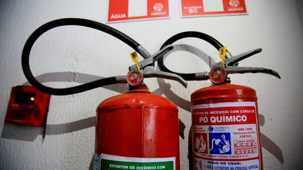 salvador, bahia / brazil - june 29, 2020: extinguisher for fire is seen in corridor of residential building in the city of Salvador.