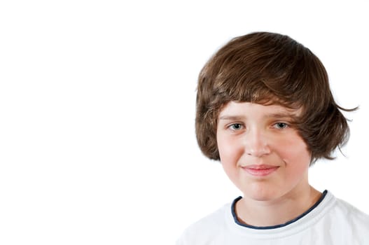 Frontal head-and-shoulders portrait of a young male Caucasian teenager against white background looking friendly at the camera.