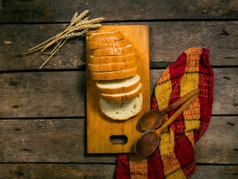 Wheat and bread on table