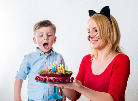 Little boy with mum and the birthday cake