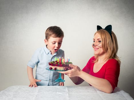 Little boy with mum and the birthday cake