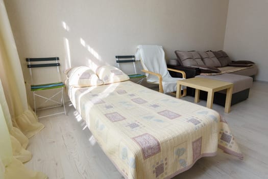 Close-up bed in a bedroom interior of a studio apartment