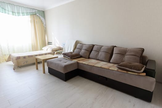 Bedroom interior with large sofa and bed