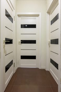 Three closed interior doors in the corridor