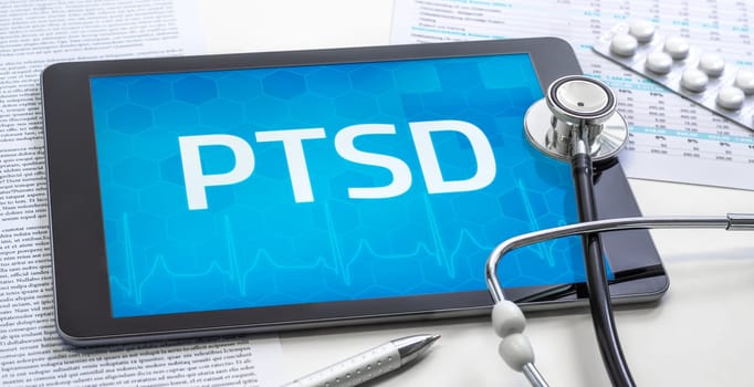 The word PTSD on the display of a tablet