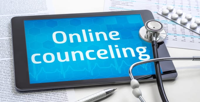 The word Online counceling on the display of a tablet