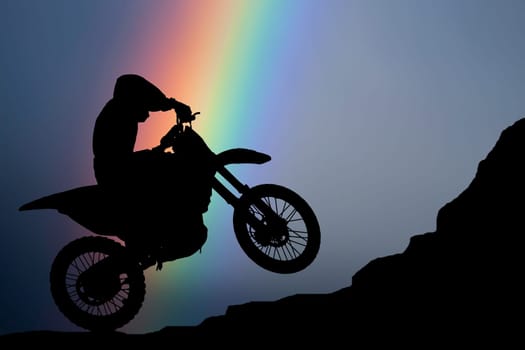 Motocross - silhouette with colorful rainbow in the sky