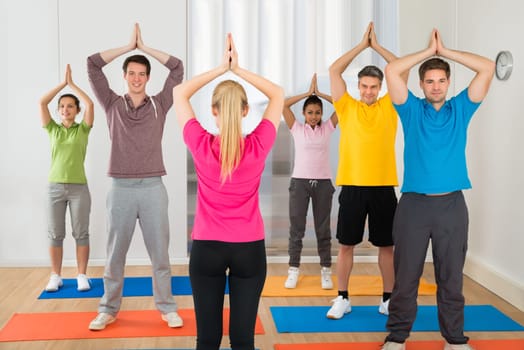 Yoga Instructor And Students At Yoga Class