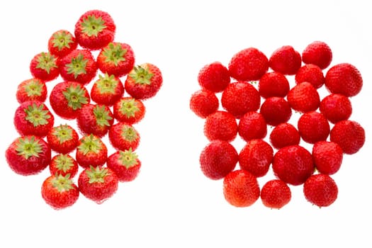 Many garden strawberries arranged in two groups. One group has the strawberry leaves facing up, the other has the little stems facing down. Metaphor for difference. Cutout isolated on white. Closeup.