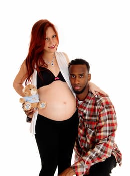 An African American man holding his ear on his wife's baby belly,.isolated for white background..