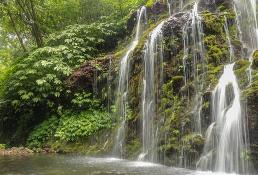 Banyuwala waterfall in Bali island, Indonesia. Scenic waterfall high in the mountains. Having fun in the wild nature. Waterfall in tropical jungle. Bali Travel Concept. Lifestyle. Travel photography.
