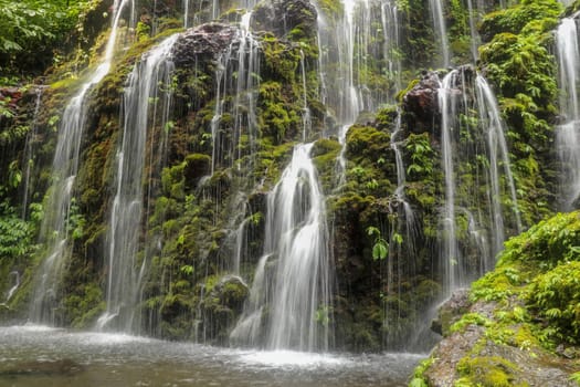 Banyuwala waterfall in Bali island, Indonesia. Scenic waterfall high in the mountains. Having fun in the wild nature. Waterfall in tropical jungle. Bali Travel Concept. Lifestyle. Travel photography.