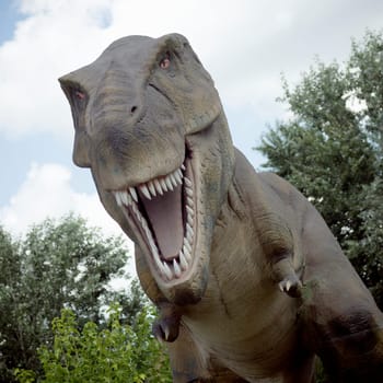 Tyrannosaurus rex dinosaur predator extinct animal is opening mouth in nature.