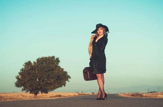 Retro beautiful blond woman portrait on road