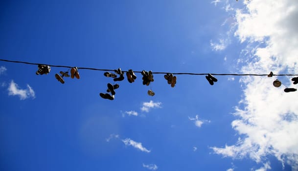 salvador, bahia / brazil - july 1, 2020: shoes are seen hanging from the electrical network's wiring in the neighborhood of Pernambues, in the city of Salvador.