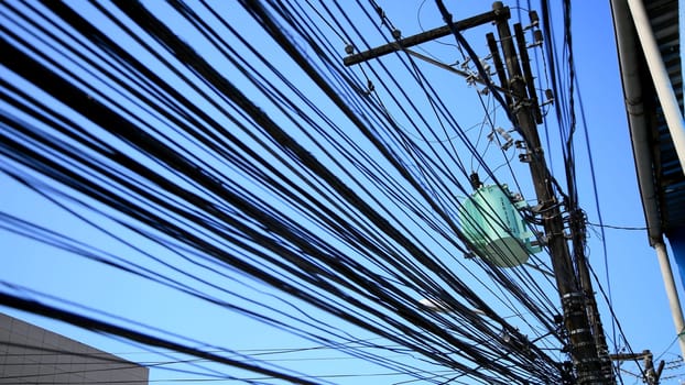 salvador, bahia / brazil - july 1, 2020: electrical network transformer is seen amidst pole wiring in the neighborhood of Pernambues, in the city of Salvador..