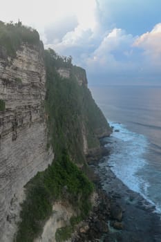Uluwatu Temple Pura Luhur Uluwatu is a Balinese Hindu sea temple located in Uluwatu. It is renowned for its magnificent location, perched on top of a cliff. Picturesque bright cliff landscape.