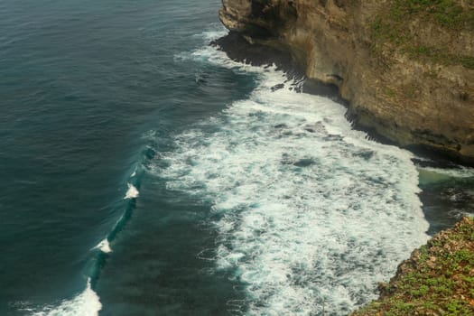 Beautiful Panoramic view of an Iconic Famous Place, Uluwatu Temple, during a vibrant summer sunrise. Amazing views at Pura Luhur Uluwatu temple in Bali Island. Nice colourful sunset with clouds.