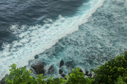 Beautiful Panoramic view of an Iconic Famous Place, Uluwatu Temple, during a vibrant summer sunrise. Amazing views at Pura Luhur Uluwatu temple in Bali Island. Nice colourful sunset with clouds.