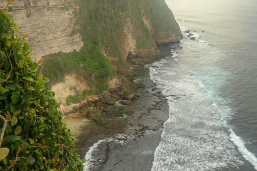 Uluwatu Temple Pura Luhur Uluwatu is a Balinese Hindu sea temple located in Uluwatu. It is renowned for its magnificent location, perched on top of a cliff. Picturesque bright cliff landscape.