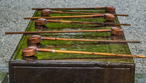 Ritual purification fountain at an Japanese Temple - TOKYO / JAPAN - JUNE 12, 2018