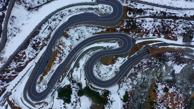 Top down view over a pass street in the Swiss mountains on a winterÂ´s day - aerial photography