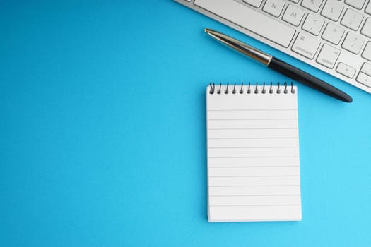 Flat lay of business with office stationary concept on blue background. Business and Copy Space concept