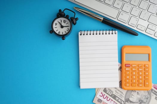 Flat lay of business with office stationary concept on blue background. Business and Copy Space concept