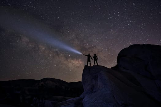 Happy Couple Silhouette Under the Stars at Night