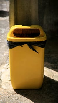 salvador, bahia / brazil - july 2, 2020: yellow trash can is seen in a condominium area in the city of Salvador..
