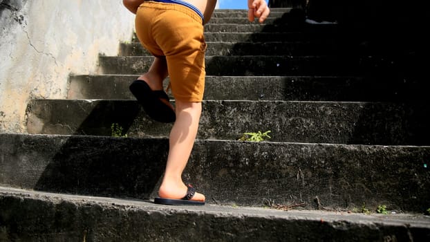 salvador, bahia / brazil - july 2, 2020: child is seen climbing stairs in residential condominium in the city of Salvador.